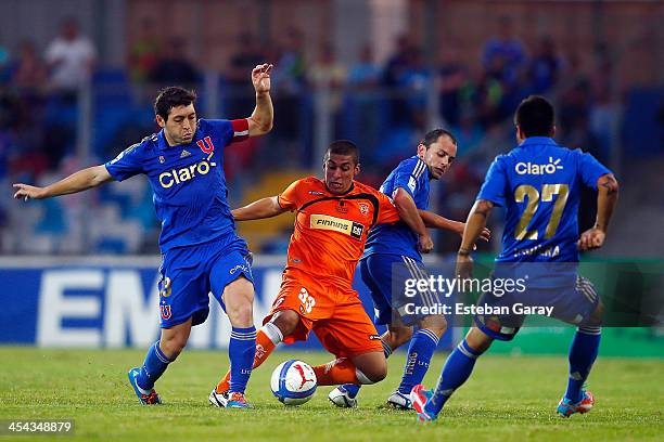 Jose Rojas of Universidad de Chile, struggles for the ball with Paolo Gomez of Cobreloa during a match between Cobreloa and Universidad de Chile as...