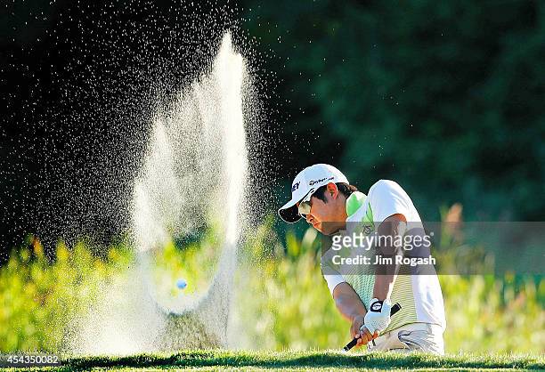 John Huh hits his shot out of the bunker on the eighth hole during the first round of the Deutsche Bank Championship at the TPC Boston on August 29,...