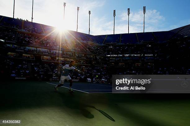 Martin Klizan of Slovakia returns a shot against Tomas Berdych of the Czech Republic during their men's singles second round on Day Five of the 2014...