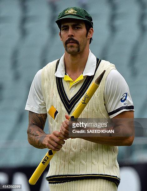 Australia's cricketer Mitchell Johnson celebrates their victory over England in the second Ashes cricket Test match in Adelaide on December 9, 2013....
