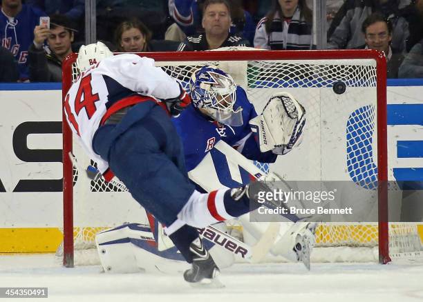 Mikhail Grabovski of the Washington Capitals scores on Henrik Lundqvist of the New York Rangers on a penalty shot during the second period at Madison...