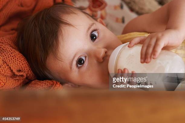 drinking her bottle before bed - milk powder stock pictures, royalty-free photos & images