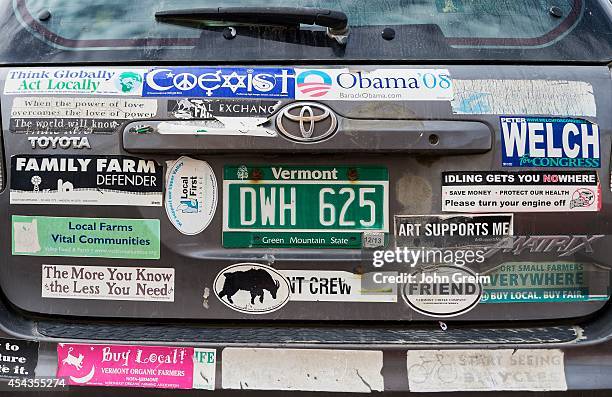 Vermont car covered with bumper sticker messages in support of local farming.