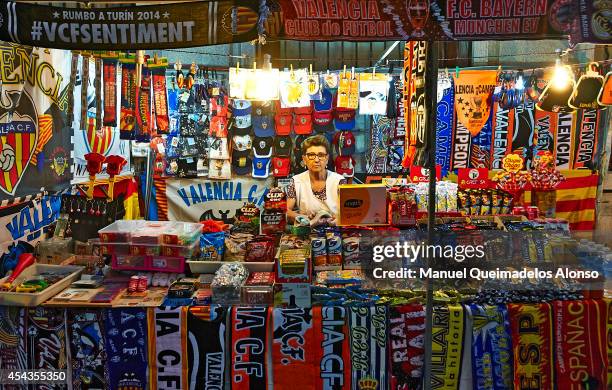 Vendor works at a merchandise stall prior to the La Liga match between Valencia CF and Malaga CF at Estadi de Mestalla on August 29, 2014 in...