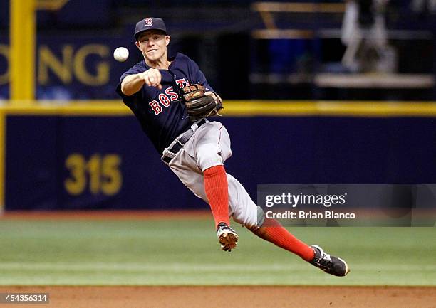 Shortstop Brock Holt of the Boston Red Sox fields the single by Evan Longoria of the Tampa Bay Rays during the eighth inning of a game on August 29,...