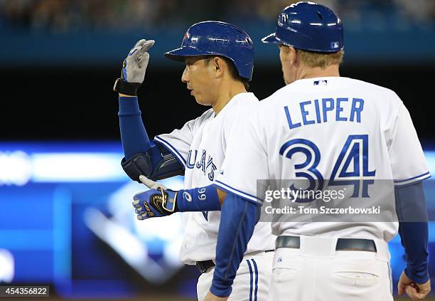 Munenori Kawasaki of the Toronto Blue Jays looks to the dugout after hitting a pinch-hit single in the eighth inning during MLB game action against...