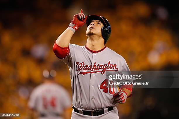 Wilson Ramos of the Washington Nationals points skyward as he crosses home plate on a solo home run in the fourth inning against the Seattle Mariners...