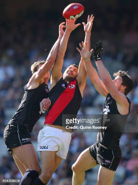 Patrick Ryder of the Bombers marks inbetween Cameron Wood and Sam Rowe of the Blues during the round 23 AFL match between the Carlton Blues and the...