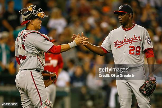 Closing pitcher Rafael Soriano of the Washington Nationals is congratulated by catcher Wilson Ramos after defeating the Seattle Mariners 8-3 at...