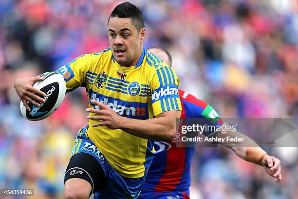 Jarryd Hayne of the Eels evades Beau Scott of the Knights during the round 25 NRL match between the Newcastle Knights and the Parramatta Eels at...