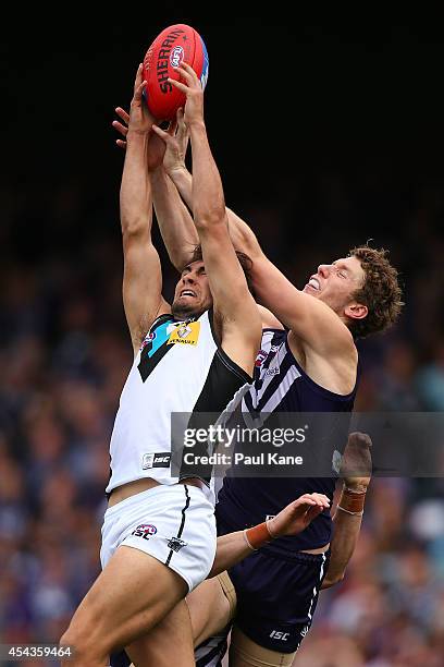 Chad Wingard of the Power marks the ball against Zac Dawson of the Dockers during the round 23 AFL match between the Fremantle Dockers and the Port...