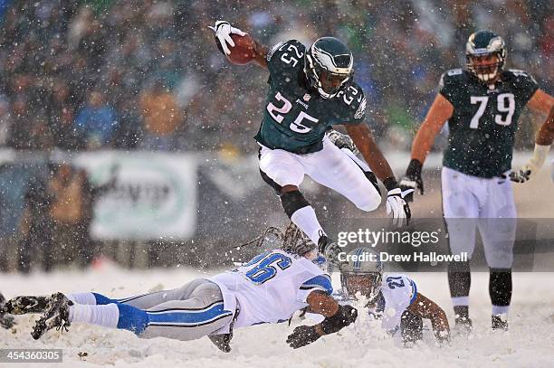 LeSean McCoy of the Philadelphia Eagles jumps over Louis Delmas of the Detroit Lions and runs for his first touchdown of the game at Lincoln...