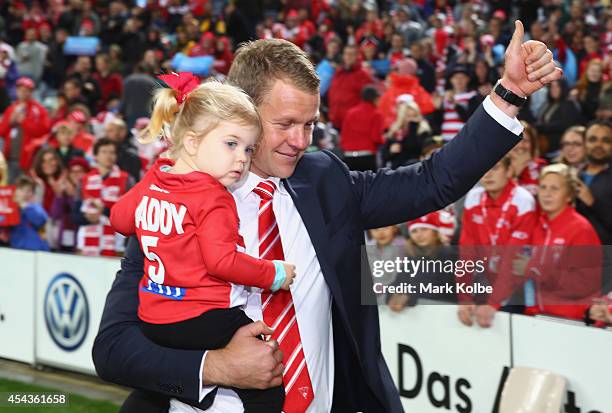 Retiring Swans player Ryan O'Keefe walks with his children on a lap of honour during the half time break of the round 23 AFL match between the Sydney...