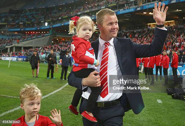 Retiring Swans player Ryan O'Keefe walks with his children on a lap of honour during the half time break of the round 23 AFL match between the Sydney...