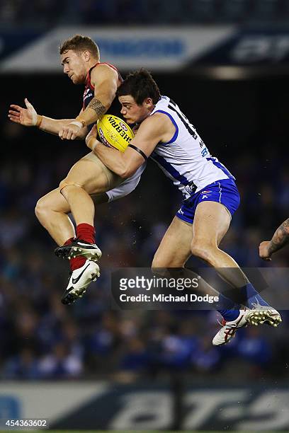 Nathan Grima of the Kangaroos marks the ball against Dean Kent of the Demons during the round 23 AFL match between the North Melbourne Kangaroos and...