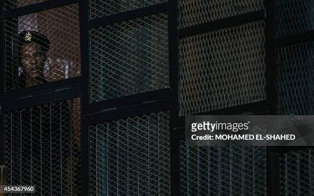 An Egyptian court security member looks on during a sentencing for the Egyptian Muslim Brotherhood leader, Mohamed Badie, at a court in Cairo, on...