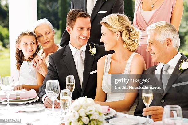 bride and groom looking at each other during reception - familys revenge of the bridesmaids stockfoto's en -beelden