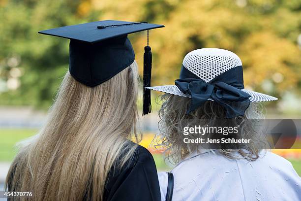 Graduate in gown and caps and his mother celebrate their graduation at the HHL Leipzig Graduate School of Management on August 30, 2014 in Leipzig,...