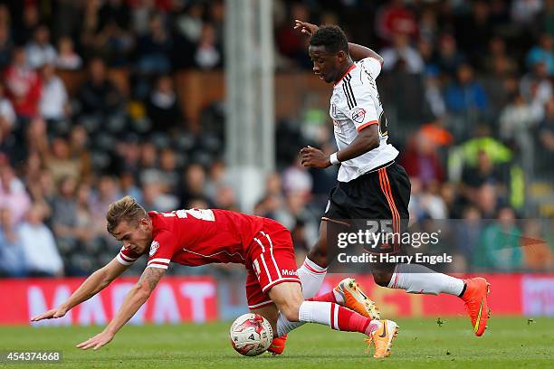 Joe Ralls of Cardiff City is brought down bt Moussa Dembele of Fulham during the Sky Bet Championship match between Fulham and Cardiff City at Craven...