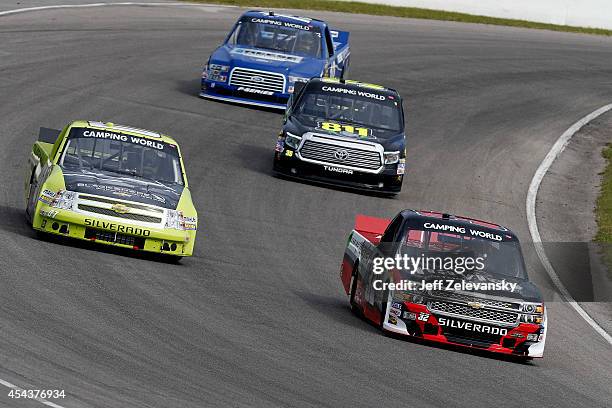 Cameron Hayley, driver of the Cabinets by Hayley Chevrolet and Roy Courtemanche Jr., driver of the La Cite DeMaribel Chevrolet, drive during practice...