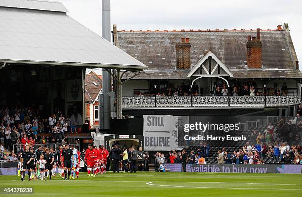 The teams walk out onto the pitch ahead of the Sky Bet Championship match between Fulham and Cardiff City at Craven Cottage on August 30, 2014 in...