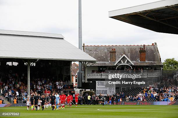 The teams walk out onto the pitch ahead of the Sky Bet Championship match between Fulham and Cardiff City at Craven Cottage on August 30, 2014 in...