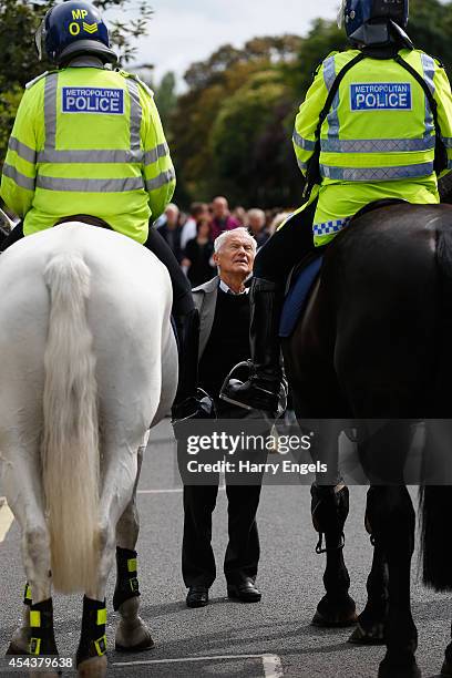 An elderly gentleman speaks to two mounted policemen during the Sky Bet Championship match between Fulham and Cardiff City at Craven Cottage on...