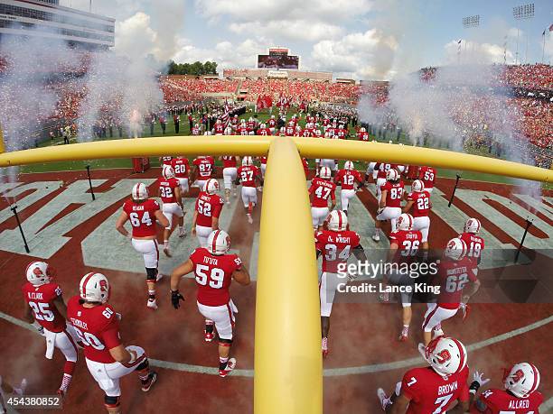 Players of the North Carolina State Wolfpack run onto the field prior to their game against the Georgia Southern Eagles at Carter-Finley Stadium on...