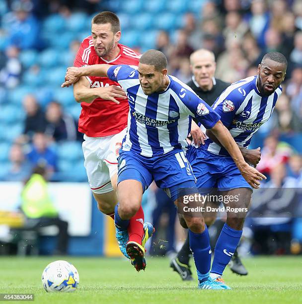 Matty Fryatt of Nottingham Forest is challenged by Giles Coke and Jacques Maghoma during the Sky Bet Championship match between Sheffield Wednesday...