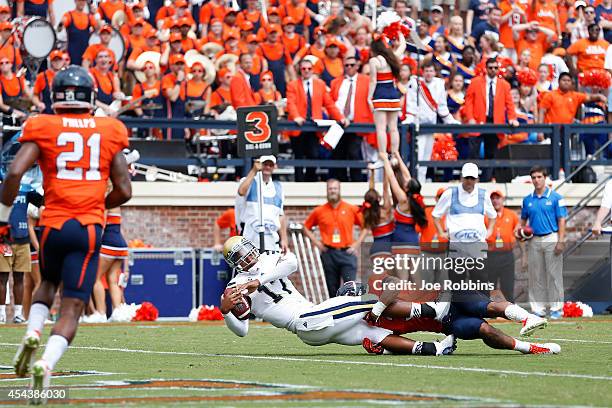 Brett Hundley of the UCLA Bruins rushes for a six-yard touchdown in the third quarter of the game against the Virginia Cavaliers at Scott Stadium on...