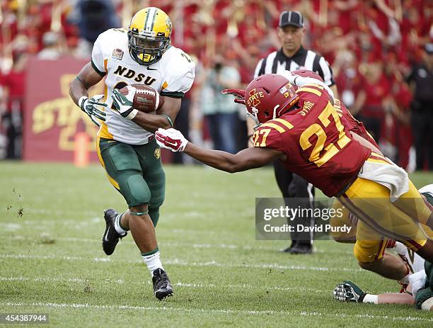 Running back John Crockett of the North Dakota State Bison rushes for yards past defensive back Kamari Syrie of the Iowa State Cyclones in the first...