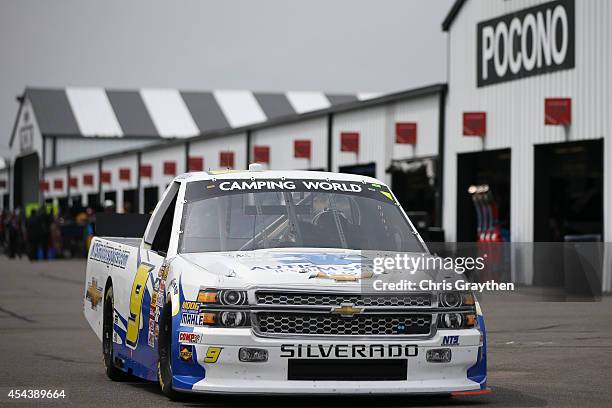 Jason White, driver of the Autism Speaks/NTS Motorsports Chevrolet, drives during practice for the NASCAR Camping World Truck Series Pocono Mountains...