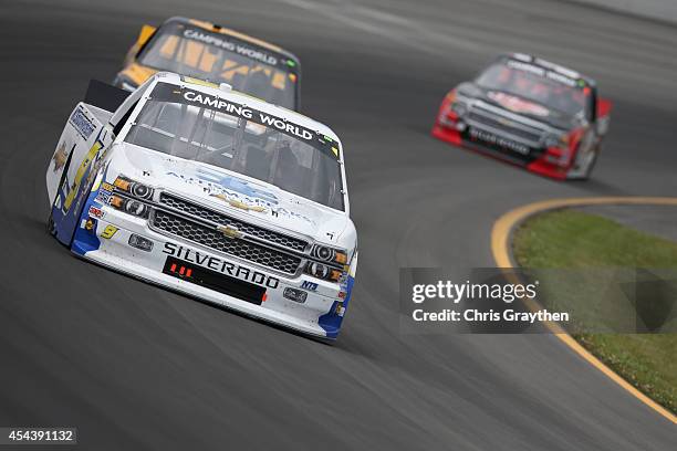 Jason White, driver of the Autism Speaks/NTS Motorsports Chevrolet, leads a pack of trucks during the NASCAR Camping World Truck Series Pocono...