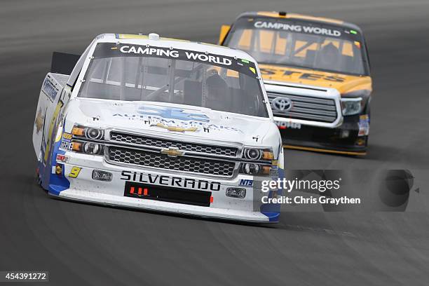 Jason White, driver of the Autism Speaks/NTS Motorsports Chevrolet, leads a pack of trucks during the NASCAR Camping World Truck Series Pocono...