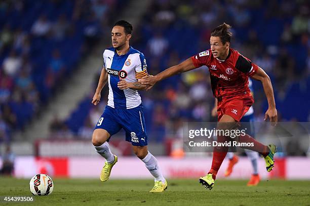 Sergio Garcia of RCD Espanyol duels for the ball with Grzegorz Krychowiak of Sevilla FC during the La Liga Match between RCD Espanyol and Sevilla FC...