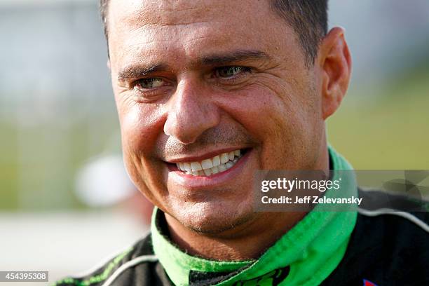 Roy Courtemanche Jr., driver of the La Cite DeMaribel Chevrolet, stands on the grid during qualifying for the NASCAR Camping World Truck Series...