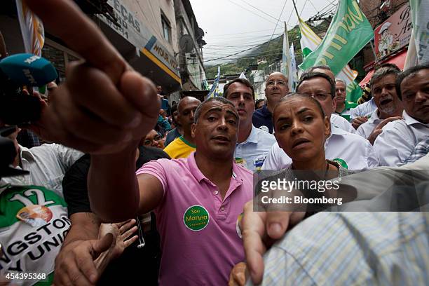 Marina Silva, Brazilian presidential candidate and former Senator, center right, takes part in a rally in the Rocinha slum in Rio de Janeiro, Brazil,...