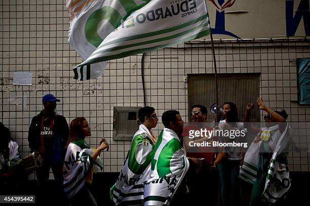 Supporters of Brazilian presidential candidate Marina Silva gather and cheer during a rally in the Rocinha slum in Rio de Janeiro, Brazil, on...