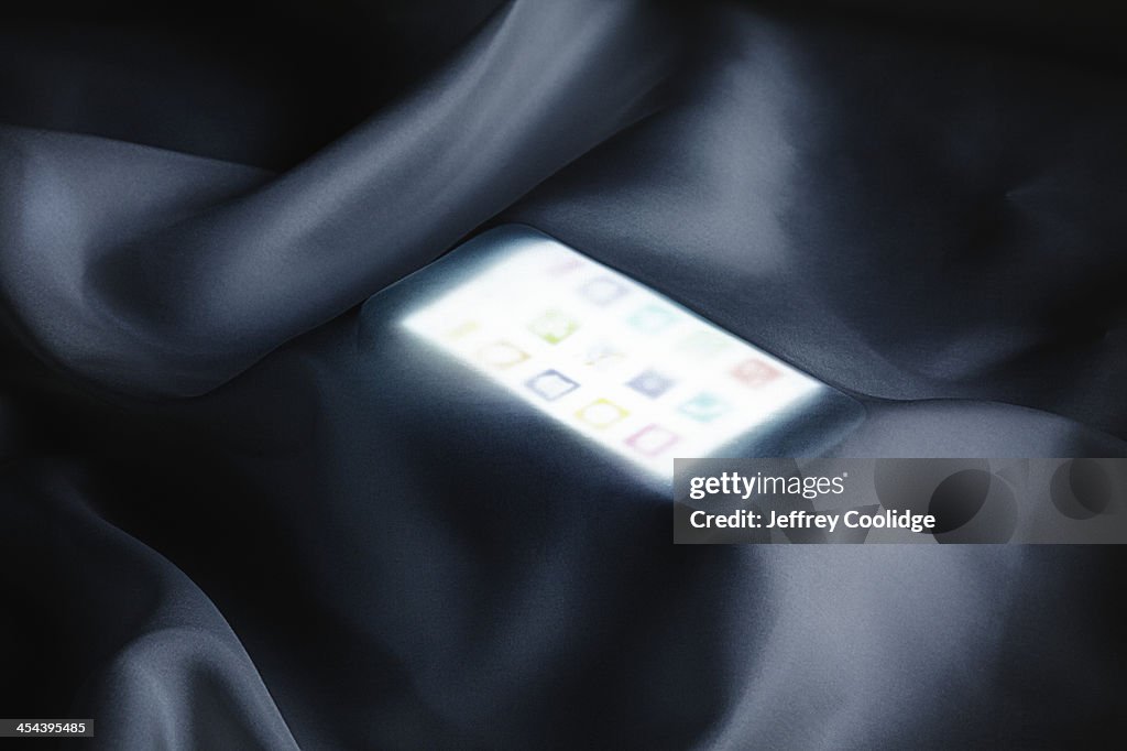 Smart Phone Glowing Under Silk
