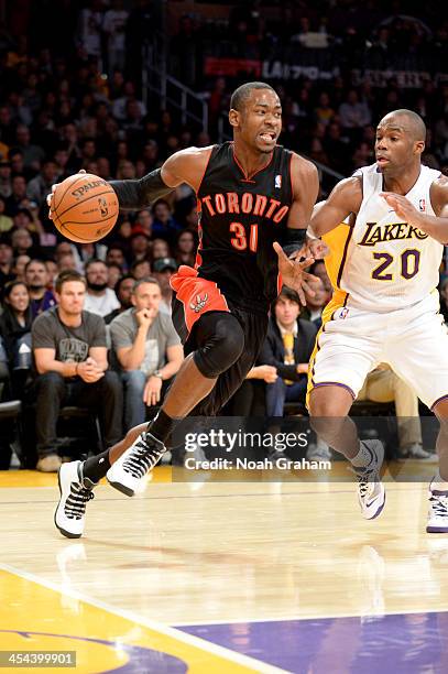 Terrence Ross of the Toronto Raptors drives to the basket against Jodie Meeks of the Los Angeles Lakers on December 8, 2013 at STAPLES Center in Los...