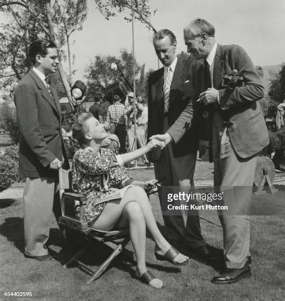 German-born photographer Kurt Hutton and Picture Post journalist Lionel Birch meet American actress Peggy Dow on the set of 'You Never Can Tell',...