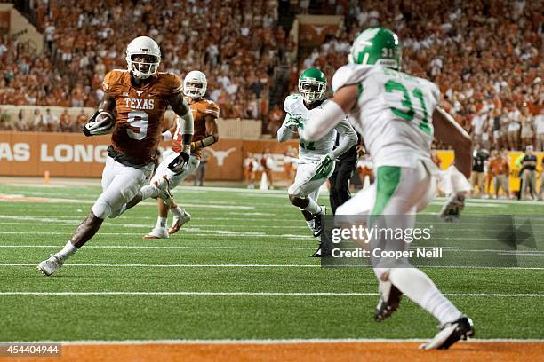 John Harris of the Texas Longhorns scores a 8 yard touchdown on a pass from David Ash against the North Texas Mean Green during the third quarter on...