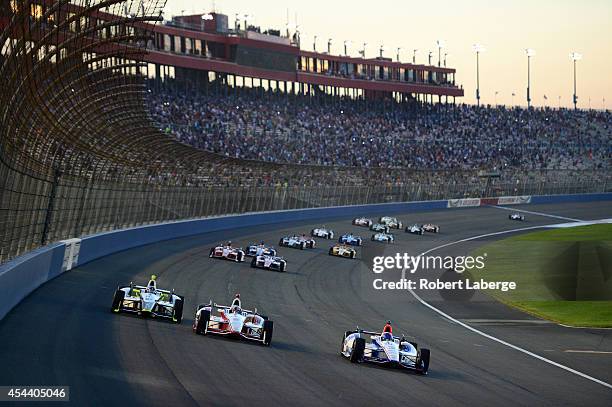 Helio Castroneves of Brazil driver of the Team Penske Dallara Chevrolet leads the field at the start of the Verizon IndyCar Series MAVTV 500 IndyCar...