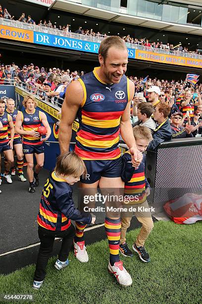 Ben Rutten of the Crows leads the team onto the ground before the round 23 AFL match between the Adelaide Crows and the St Kilda Saints at Adelaide...