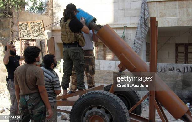 Islamic Front members prepare for bombing with propane cylinders against Aleppo's Seif al-Dowla during operation targeting the regime forces'...