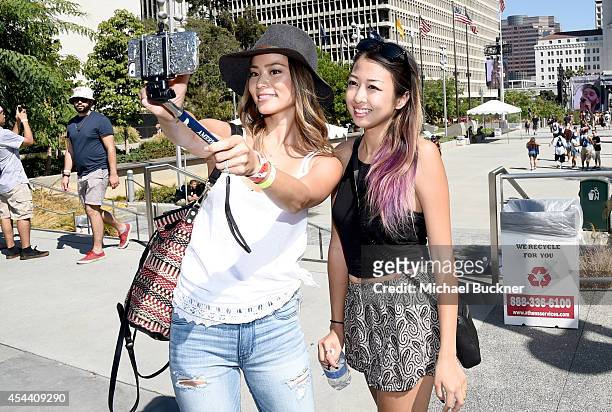 Actress Jamie Chung , wearing American Eagle Sky High Demin, takes a selfie with a music fan at American Eagle Outfitters Celebrates the Budweiser...