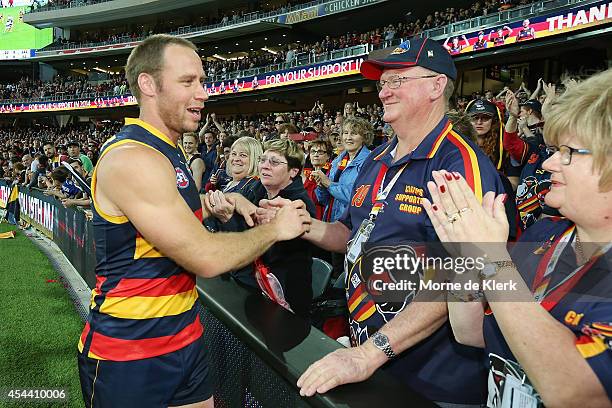 Ben Rutten of the Crows celebrates with spectators after the round 23 AFL match between the Adelaide Crows and the St Kilda Saints at Adelaide Oval...