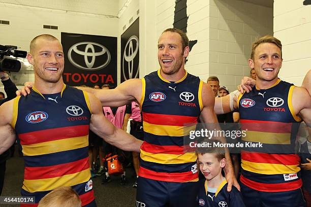 Scott Thompson, Ben Rutten and Brent Reilly of the Crows celebrates after the round 23 AFL match between the Adelaide Crows and the St Kilda Saints...