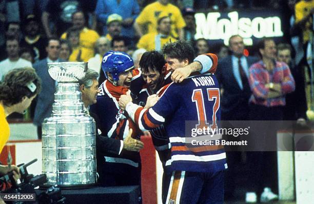 Mark Messier of the Edmonton Oilers celebrates with teammates Kevin Lowe and Jari Kurri after Game 5 of the 1990 Stanley Cup Finals against the...