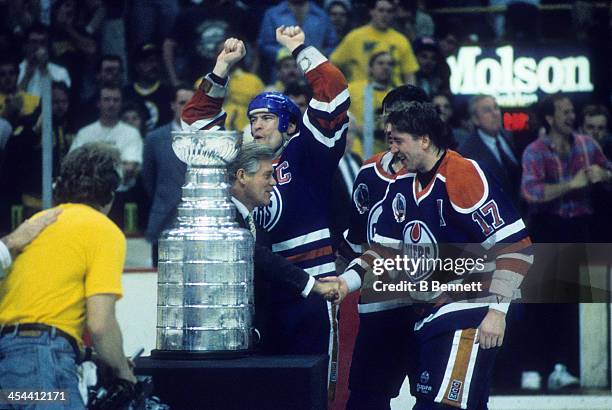 Mark Messier of the Edmonton Oilers celebrates with teammates Kevin Lowe and Jari Kurri after Game 5 of the 1990 Stanley Cup Finals against the...